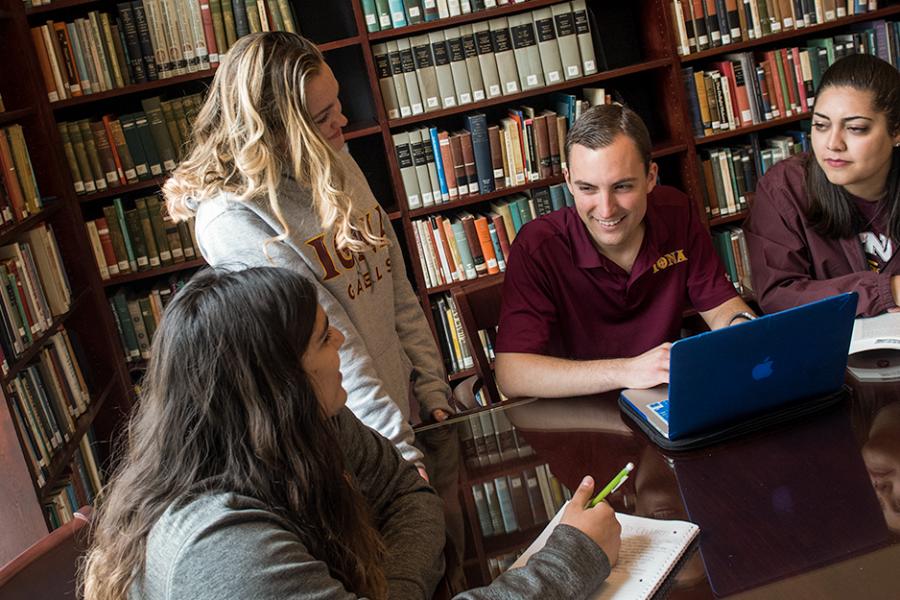 A group of English major students study together at the library.
