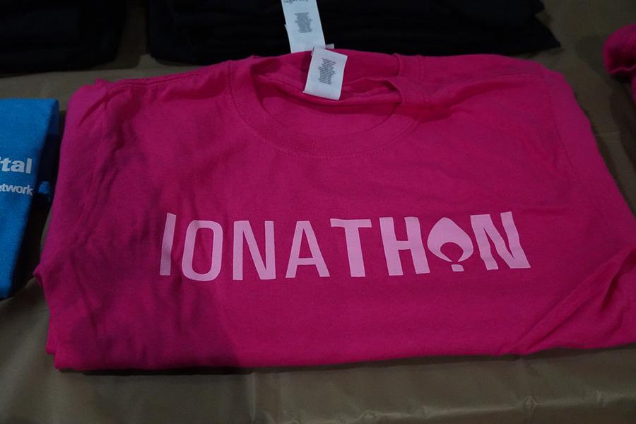 A maroon Ionathon t-shirt with pink lettering.