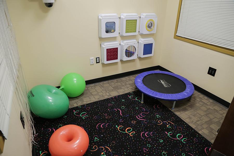 The sensory room has a small trampoline as well as large inflatable balls for children to interact with.