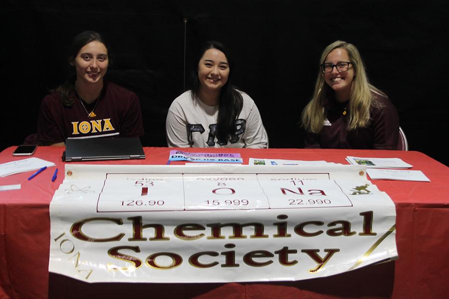 Three members of the Chemical Society recruit at their club table.