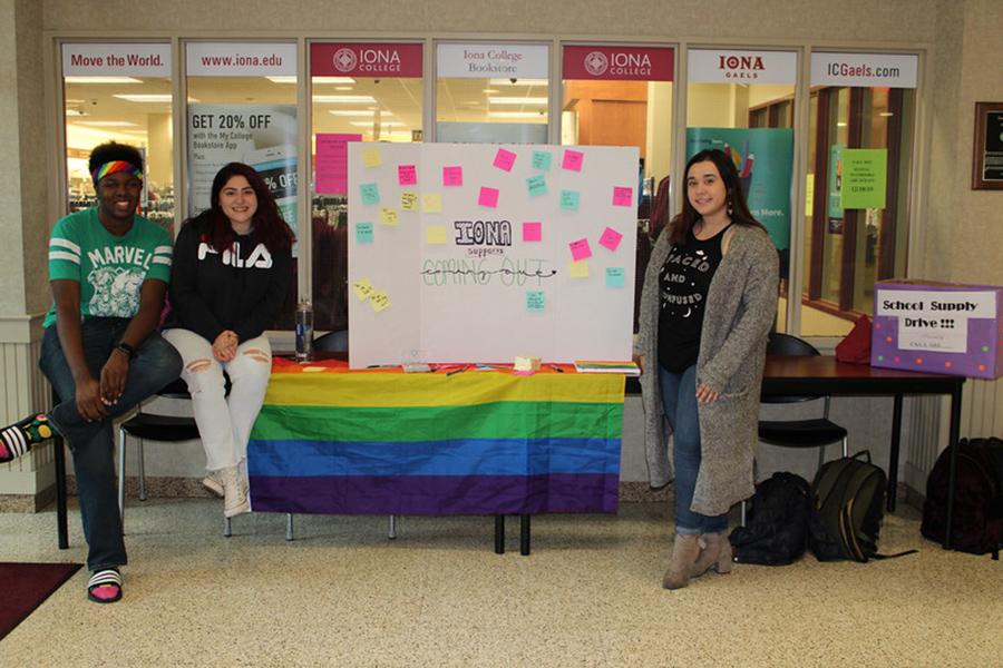 Three students from Love is Love at their club table at the LaPenta Student Union.