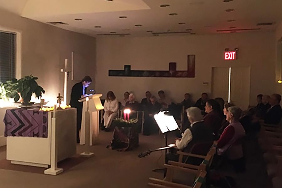Brian Brown reads reflections at an Advent Mass held in the Iona University Chapel.