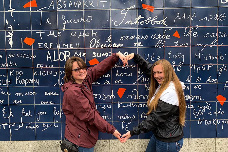Two Iona students pose with their arms in a heart during the study abroad program in France.