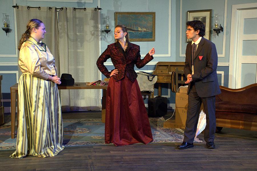 Three actors on stage in an Iona University production.
