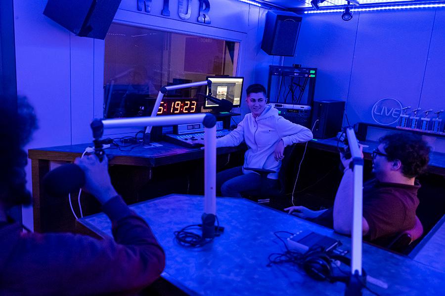 Three students work on a radio show at Iona University.