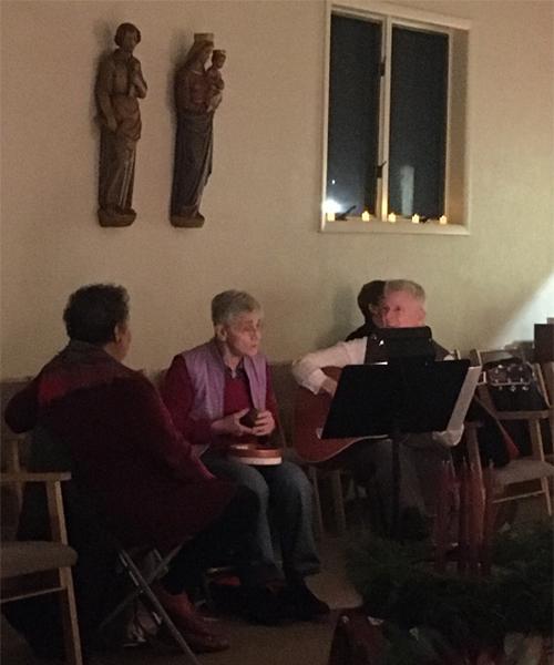 Three people are rehearsing for a choir performance for an Advent mass in the Iona University Chapel.