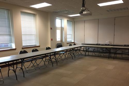 McGrath room set up with tables and chairs.