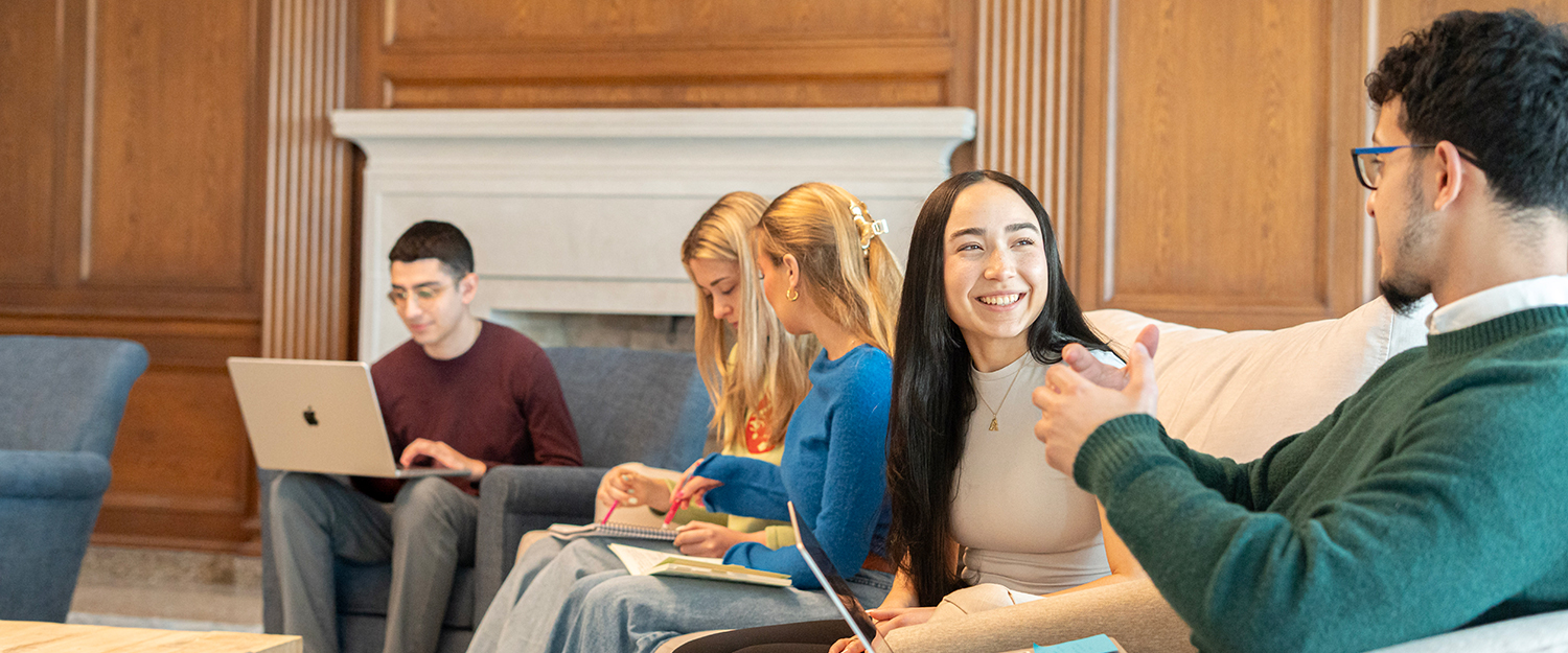 Students in Burke Lounge talking and studying together.