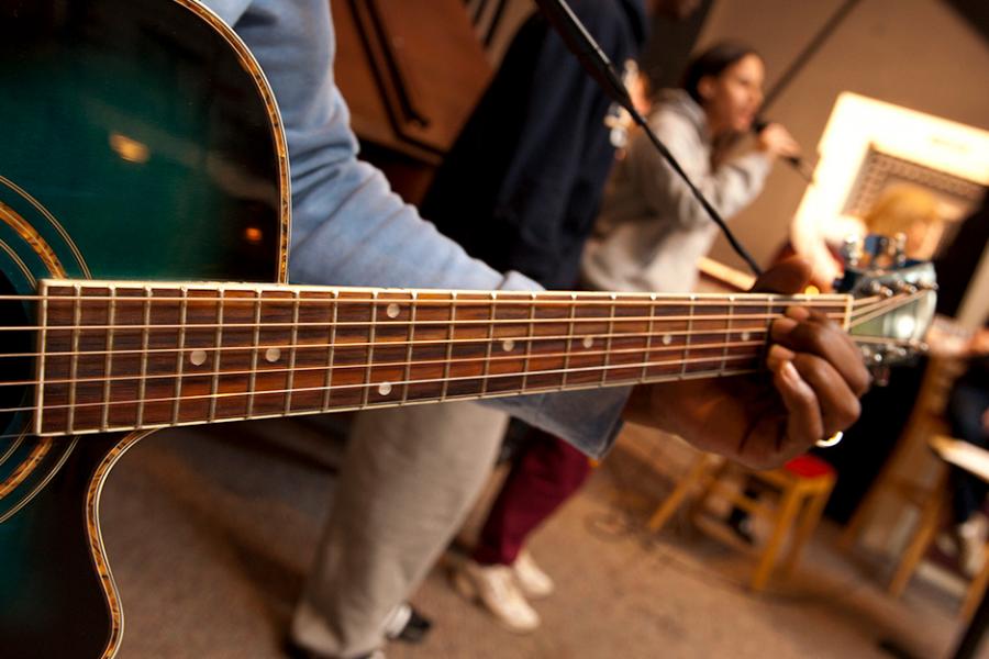 A close-up of someone playing a guitar.