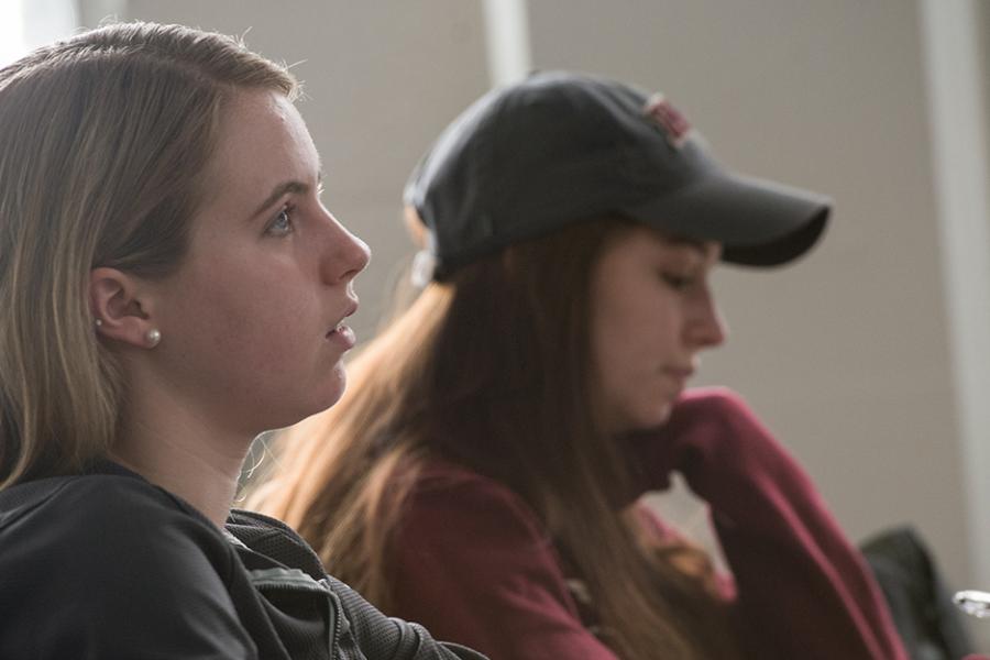 A student pays close attention during one of her management classes.