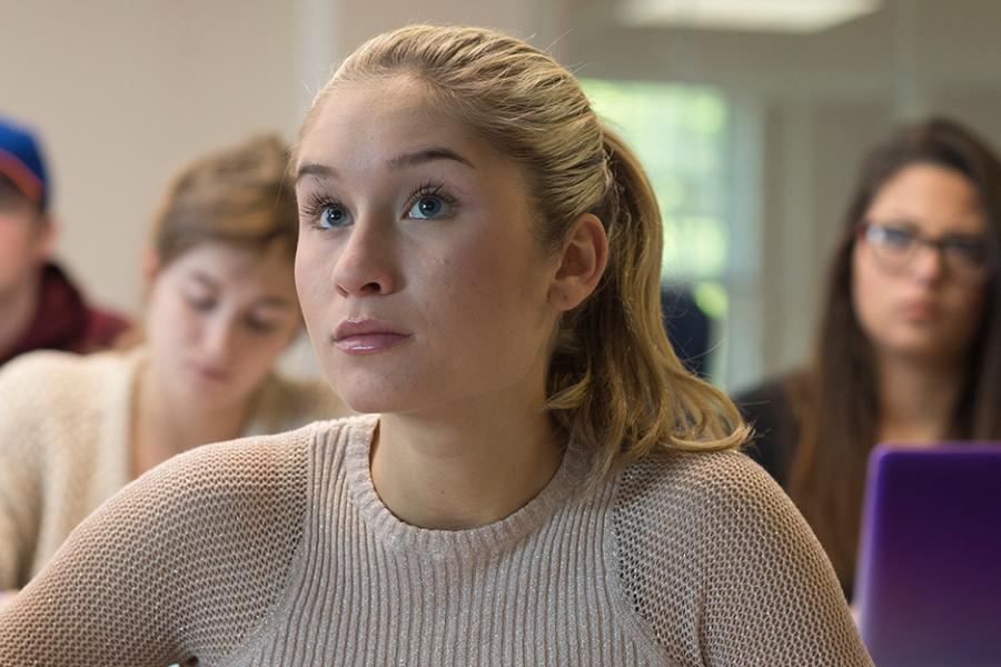 A student takes notes in an accounting class.