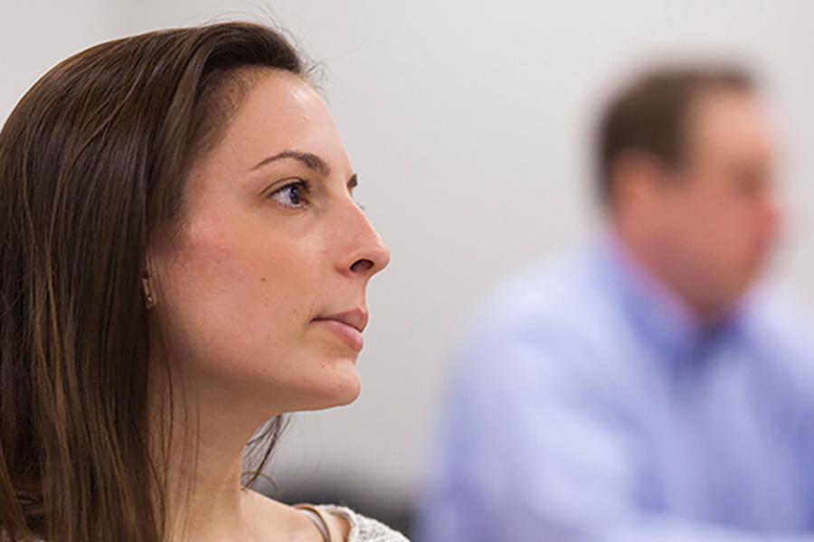 A student sits in a class for business administration.