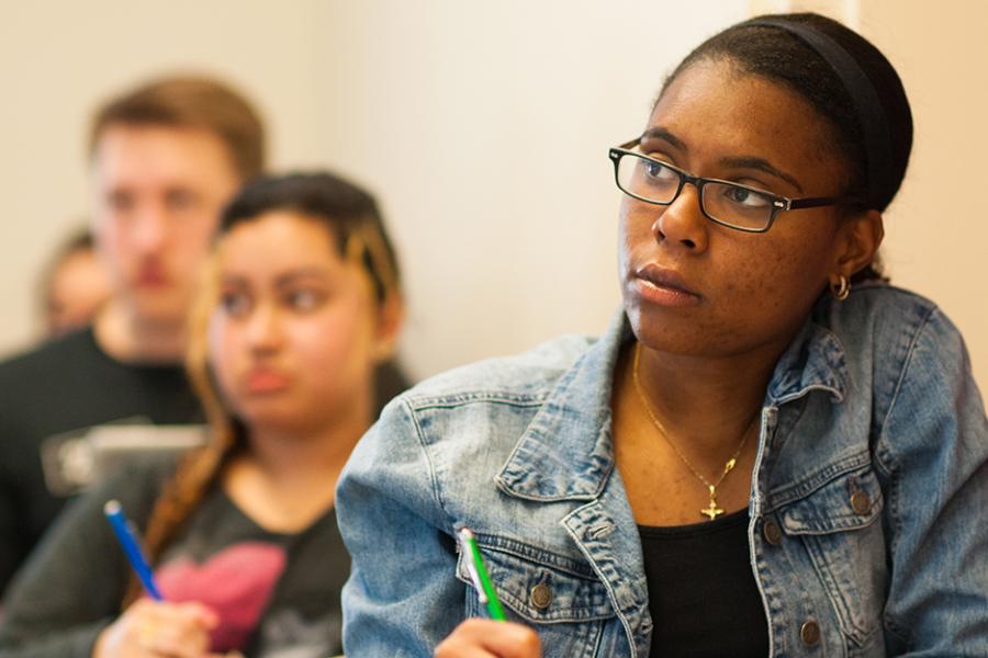 A student takes notes in her math class.