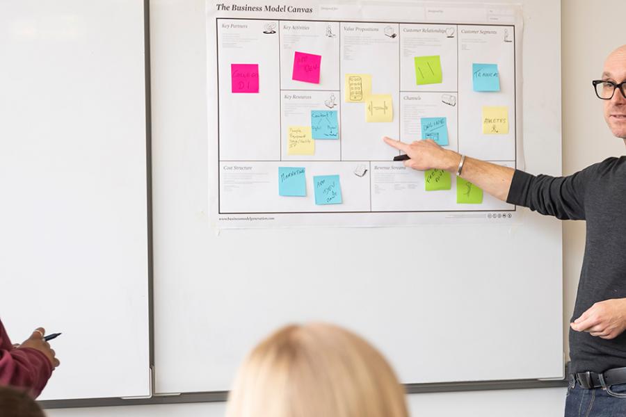 Christoph teaching at a white board in the Hynes Institute.