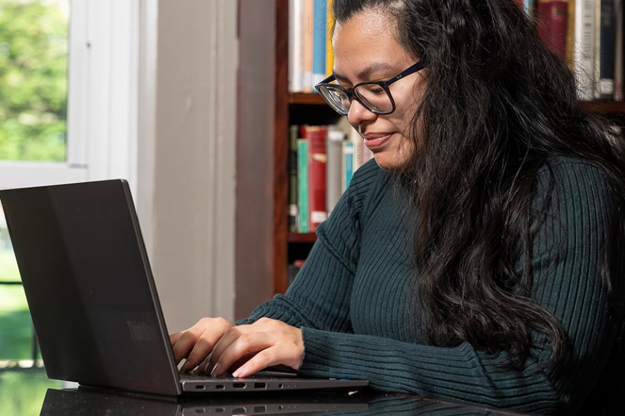 An online MBA student works at her computer.