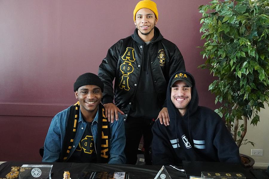 Three members of Alpha Phi Alpha recruit new members.