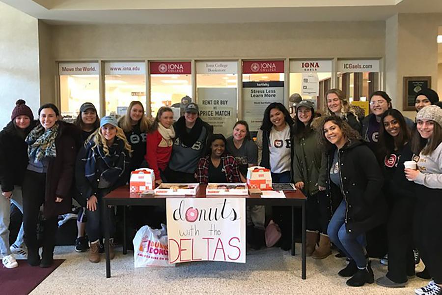 Delta Theta Beta hand out donuts to the Iona student body.