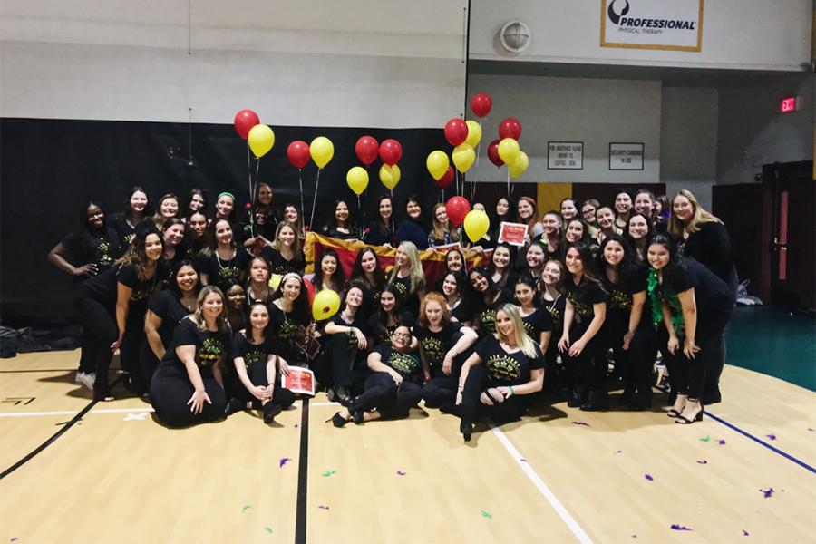 The entire Delta Theta Beta sorority in the gym.