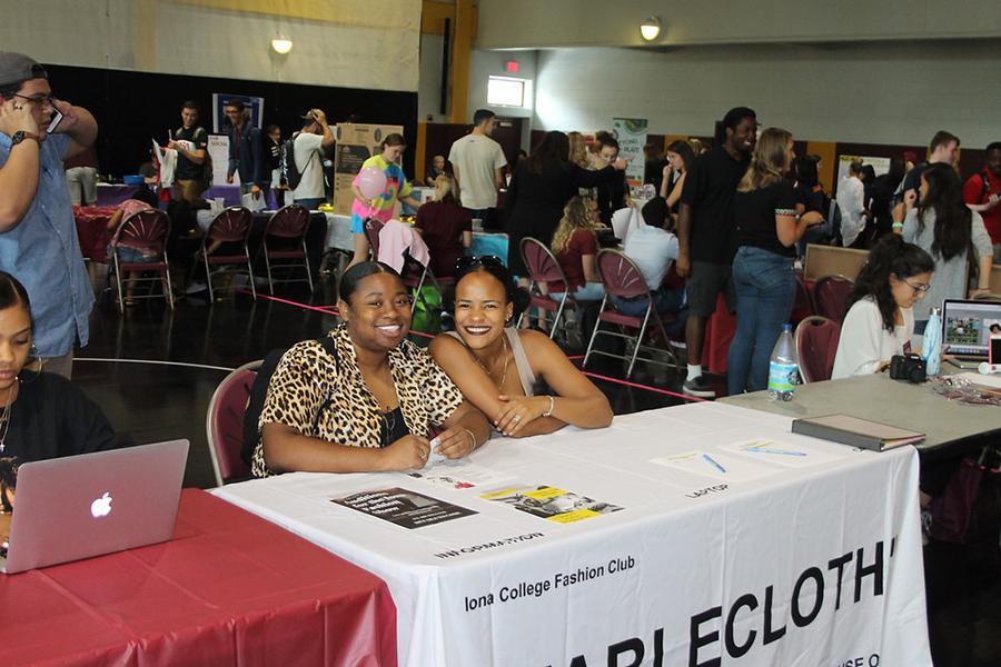 Two members of the Fashion Club at their table at the involvement fair.