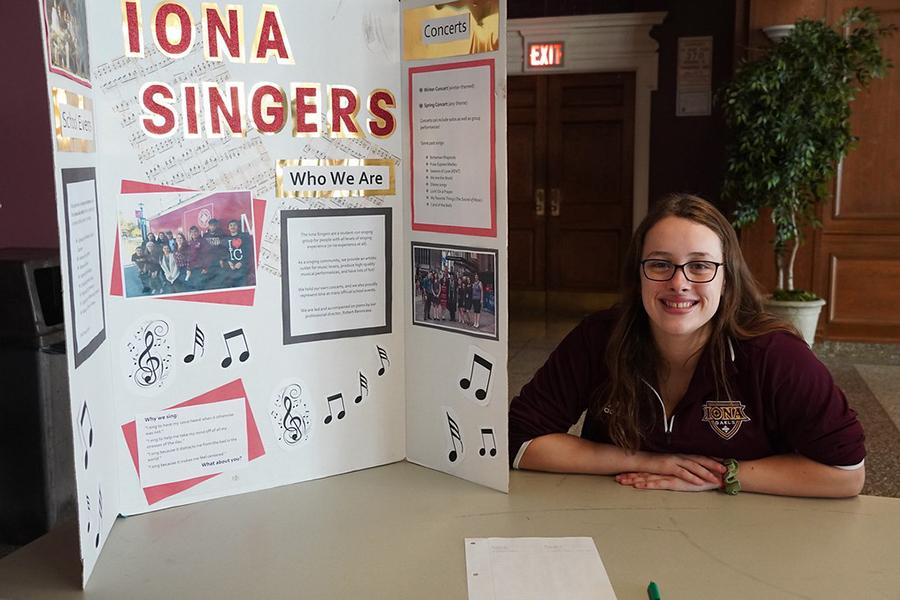 A member of the Iona Singers at their club table at the involvement fair.