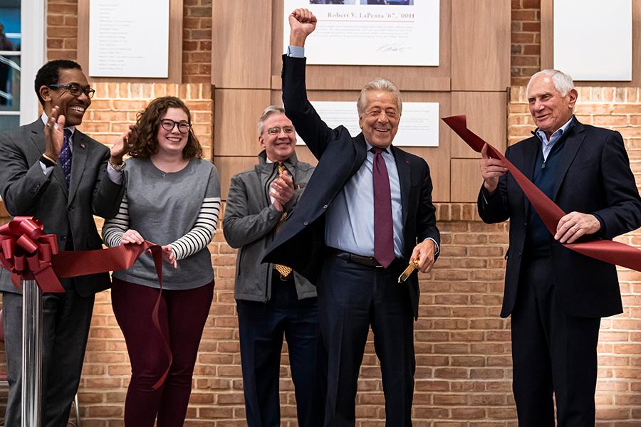 Robert LaPenta raises his fist in victory at the LaPenta School of Business ribbon cutting.