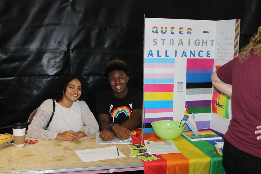 Two members of Love is Love at their table at the involvement fair.