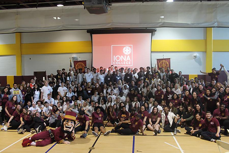 The Edmund Rice Society poses in the gym with Killian.