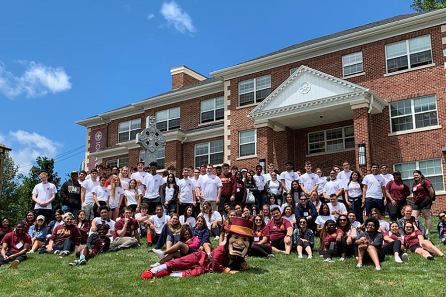 Members of many different clubs pose on the east lawn with Killian and the Celtic cross.