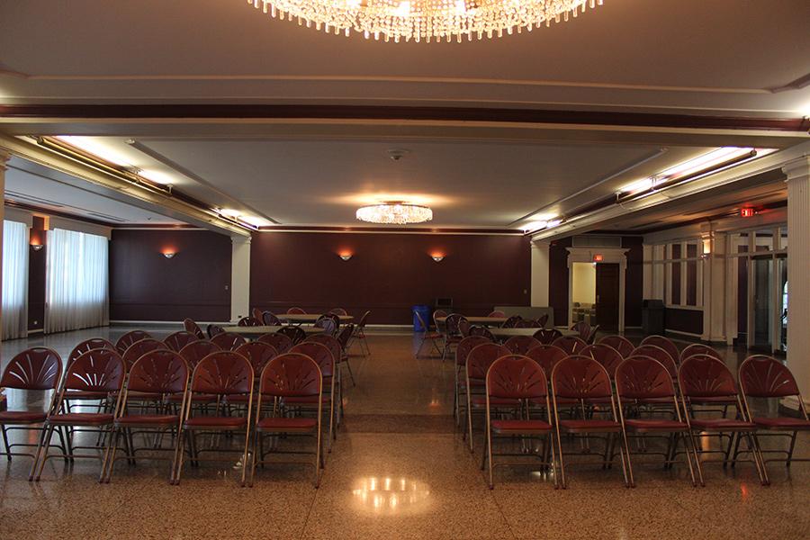 Burke Lounge is set up with several rows of chairs facing a podium.