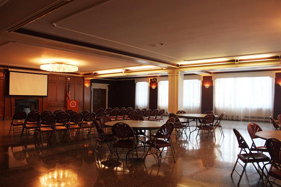 Burke Lounge is set up with several circular tables and chairs.