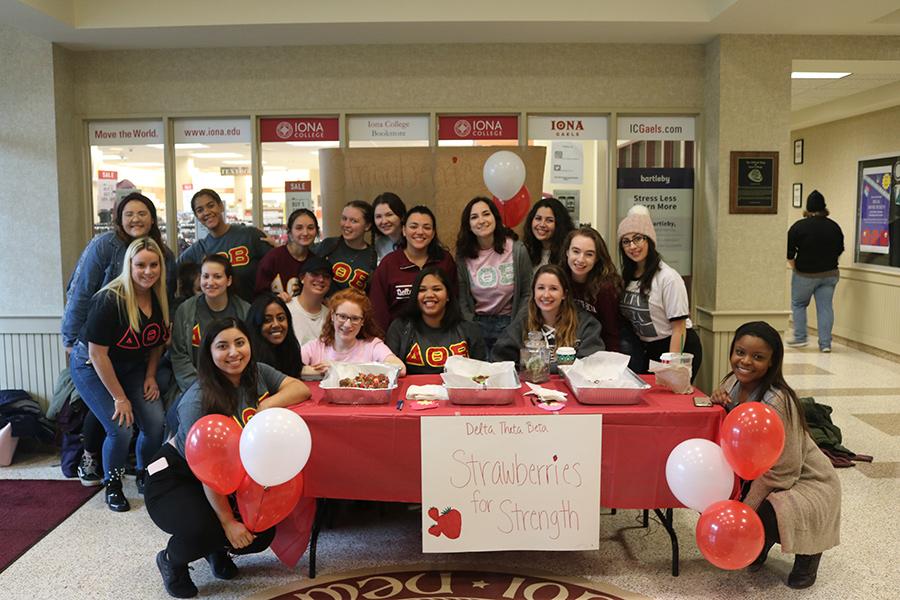 Several members of the Delta Theta Beta sorority sell chocolate covered strawberries to raise money for charity.