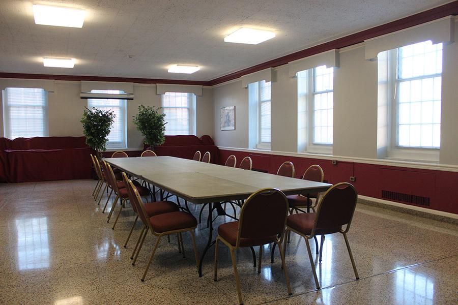Faculty Reception Room is set up with a long rectangular table and chairs.