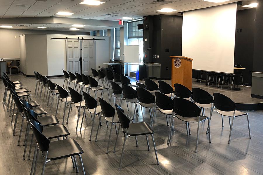 LePenta EndZone is set up with chairs as well as a projector and a small stage.