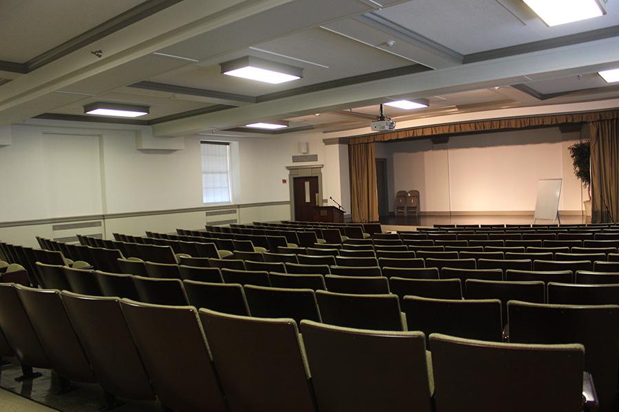 Seats in Romita Auditorium face a stage for panel discussions or small performances.