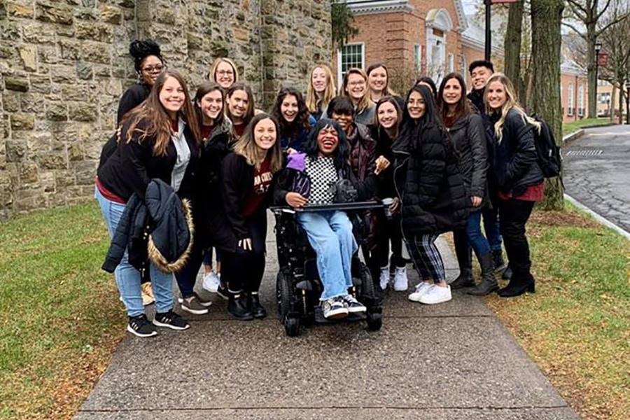 Model and author Aaron Philip poses with members of the first-year OT cohort at the Hynes Institute. 