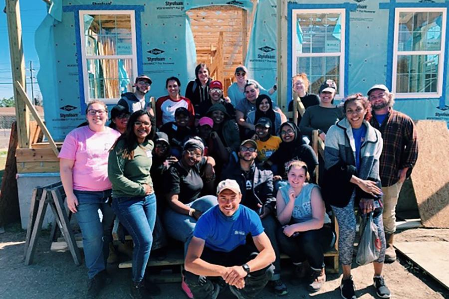 Iona students in front of a house they are building with Habitat for Humanity.