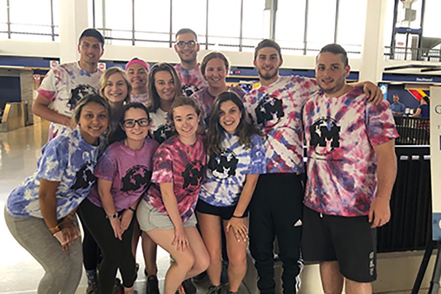 A group of students from the Mississippi mission trip pose in an airport.