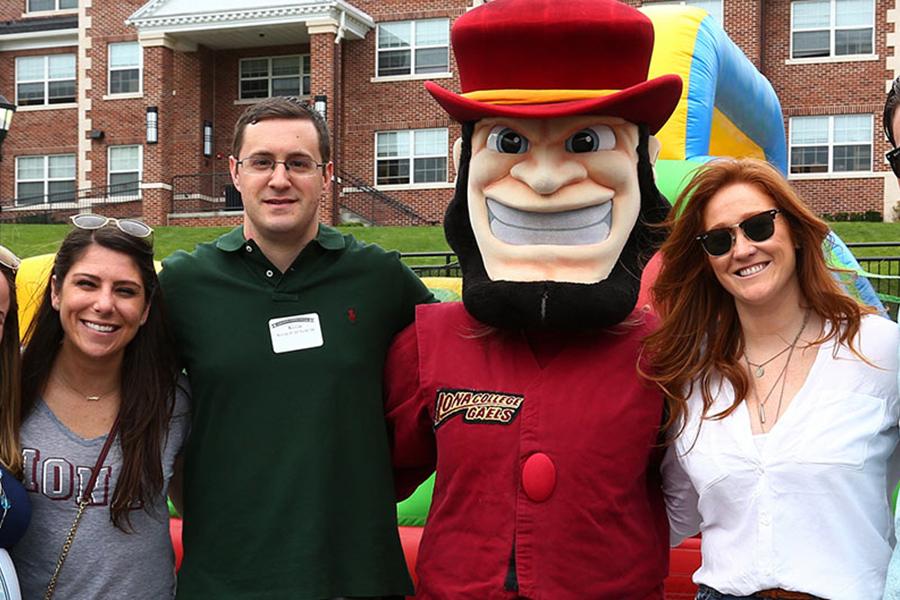 Alumni pose with Killian at a BBQ event.