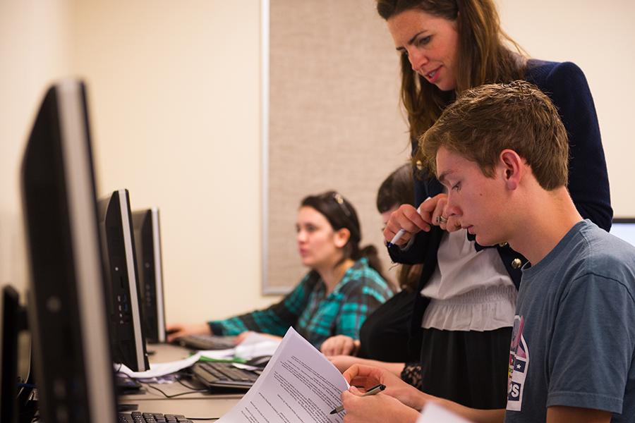 Colleen Jacobson works with a student on a paper.