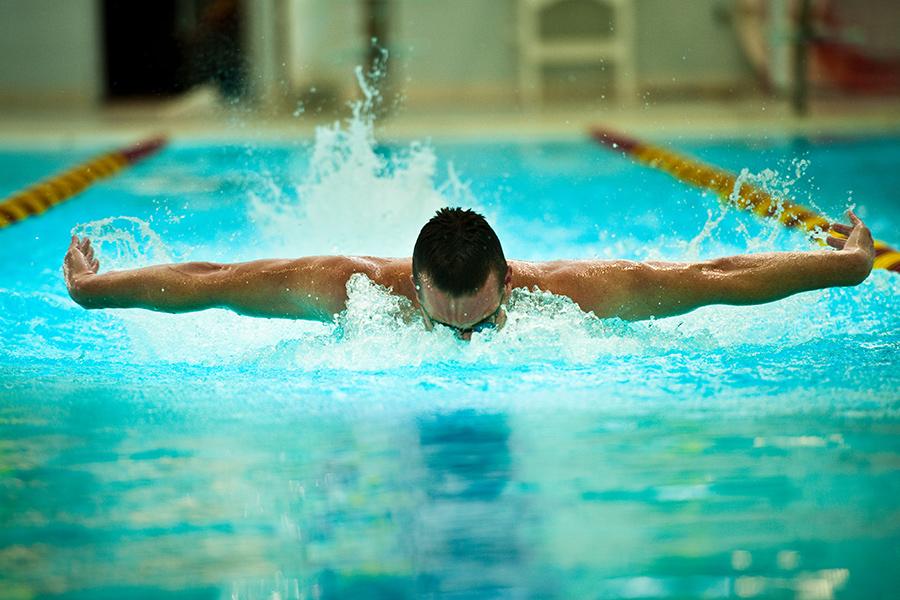A swimmer does the butterfly stroke in the pool at Iona.