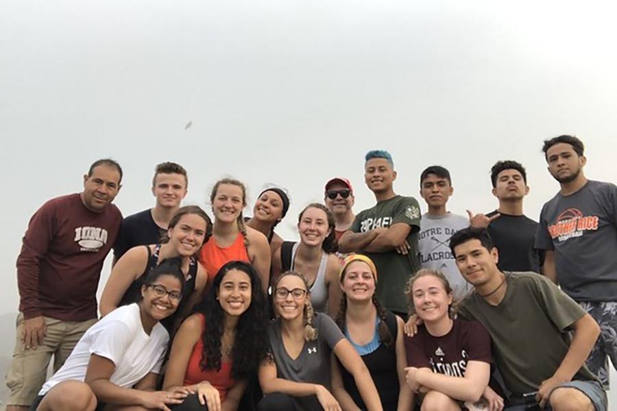 The members of the Iona Mission Trip to Peru pose on a hill.