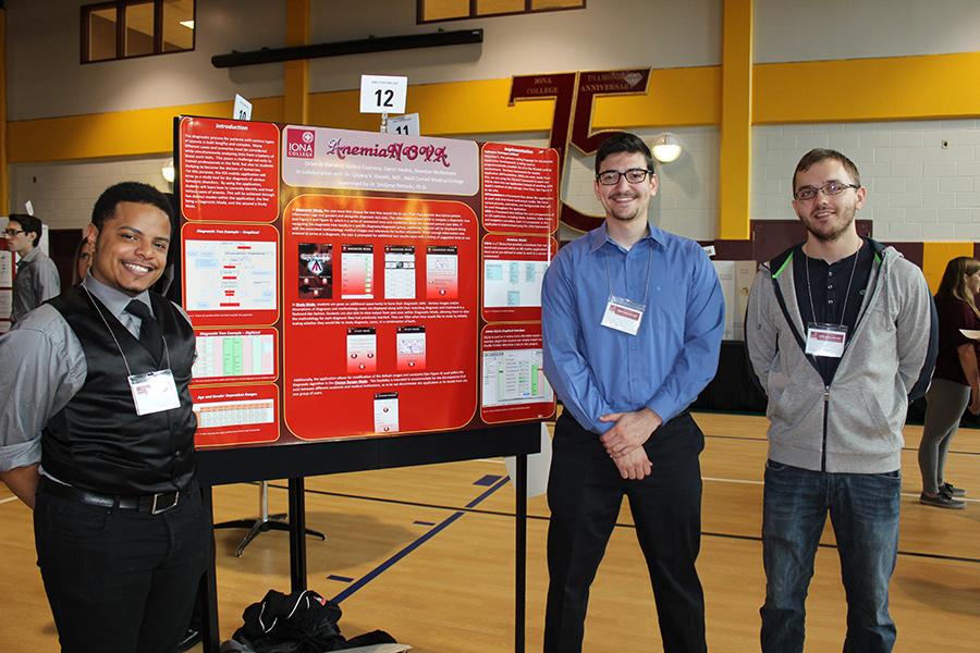 Three students stand near their poster at Iona Scholars Day 2015.