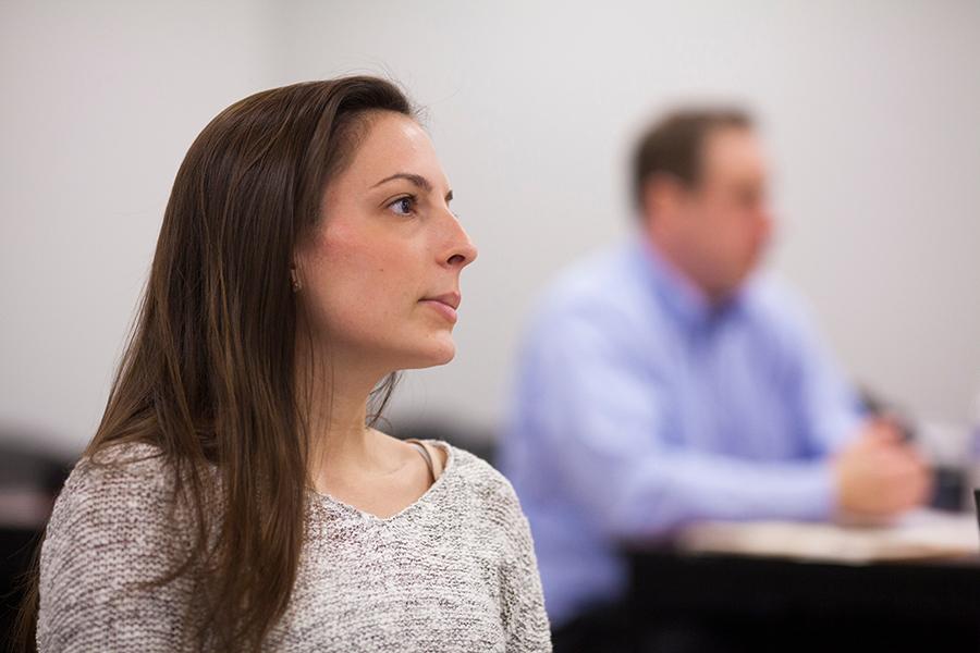 A student sits in a class for business administration.