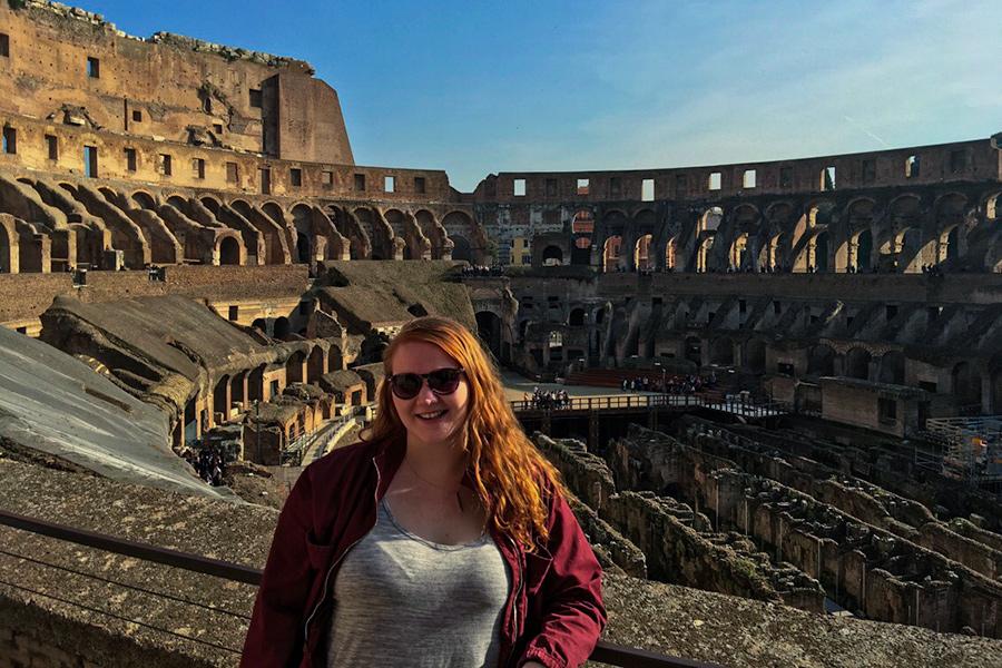 A student stands in the Colosseum in Rome, Italy.