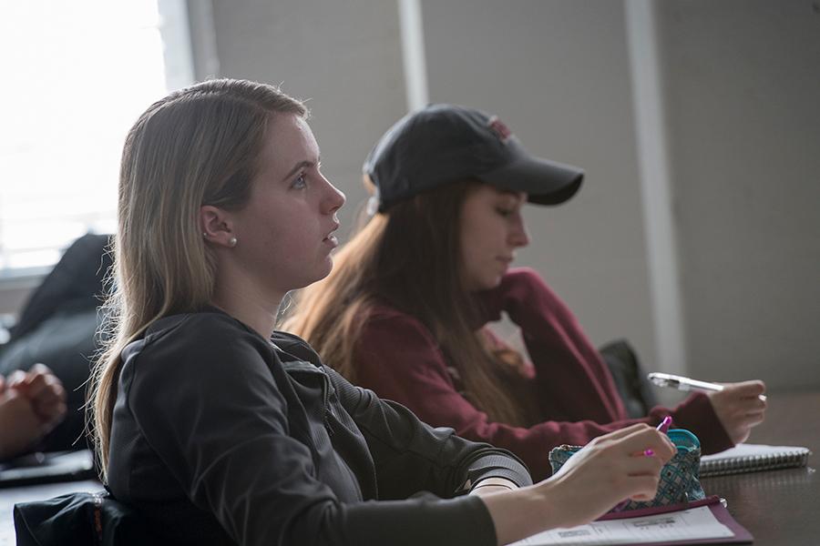 A student pays close attention during one of her management classes.