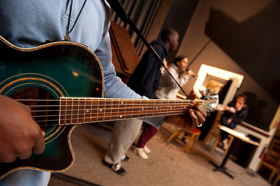 A close-up of someone playing a guitar. 