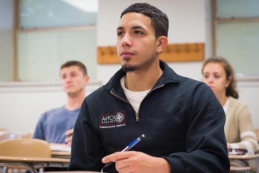 Students pay close attention in a class for their psychology MA degree.