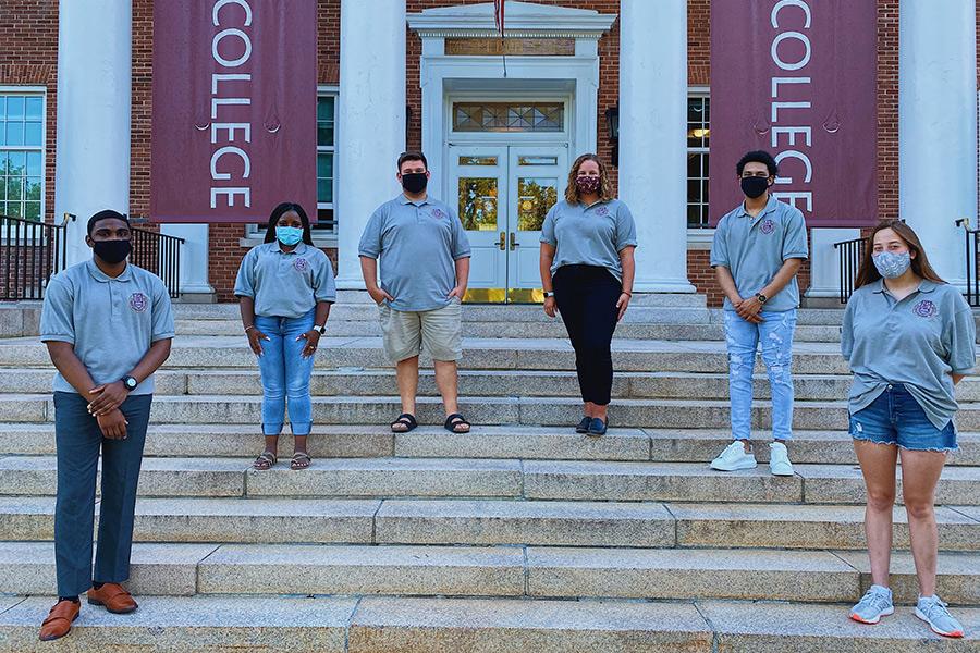 The 2020-21 student government association (SGA) stand socially distanced with masks on outside of McSpedon Hall.