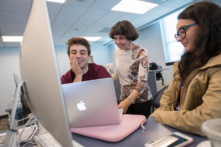 Dr. Fran Bailie helps two students in a computer science class.