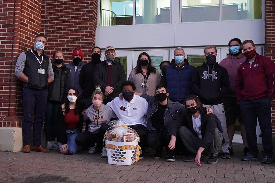 Volunteers stand outside of the Hynes Athletics center for the Thanksgiving Baskets 2020 ceremony.